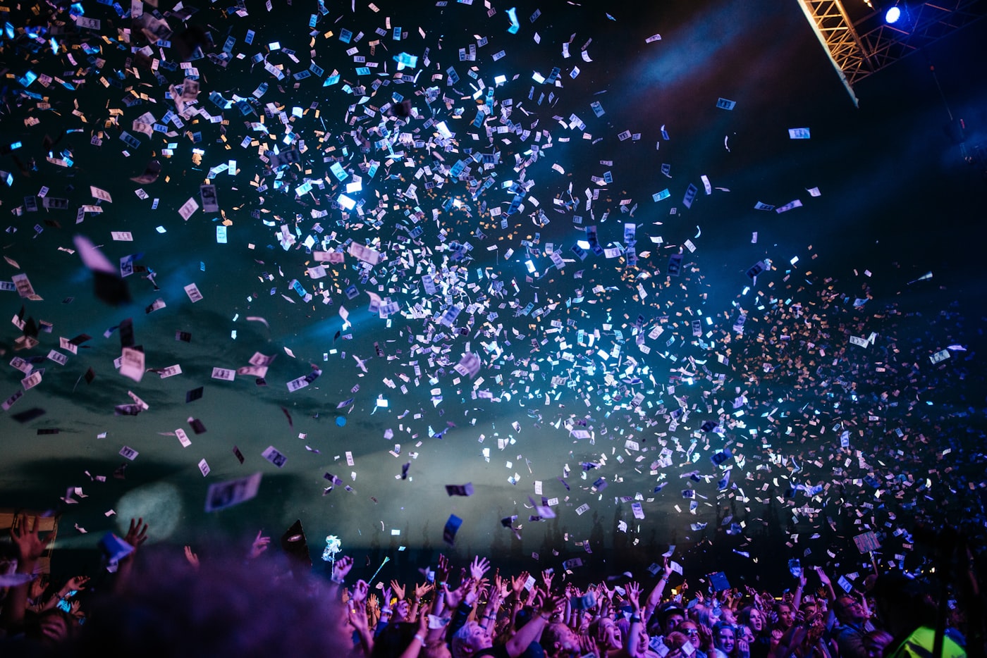 Performers on a brightly lit festival stage at night